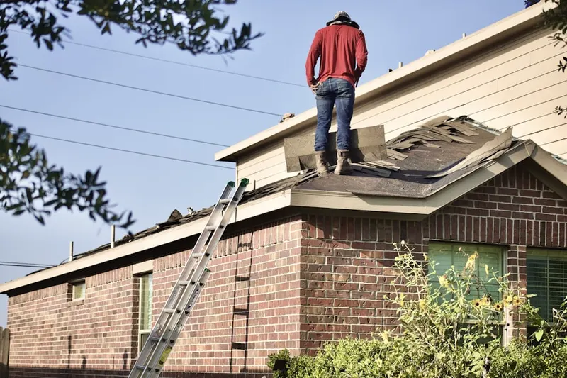 Professional roofer working on a residential roof in Johns Island